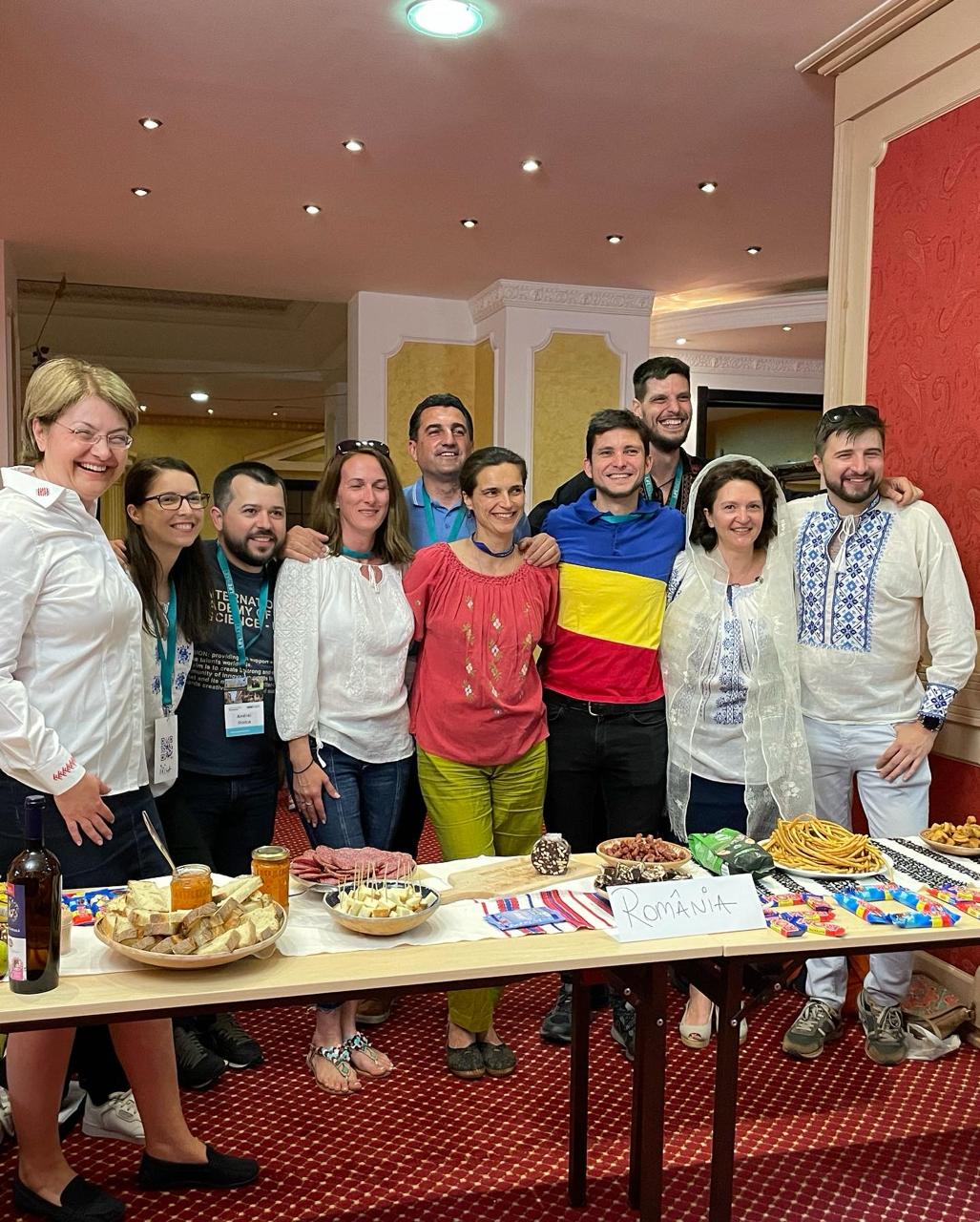 Alumni behind a table of Romanian food and snacks at the Global Village